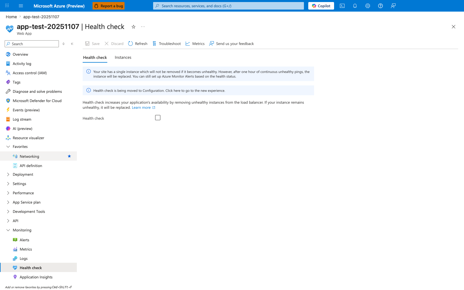 Health check blade for a Web App with two tabs — Health check (active) and Instances — and a command bar showing Save, Discard, Refresh, Troubleshoot, Metrics, and Send us your feedback actions. The first blue info banner reads "Your site has a single instance which will not be removed if it becomes unhealthy. However, after one hour of continuous unhealthy pings, the instance will be replaced. You can still set up Azure Monitor Alerts based on the health status." The second blue info banner reads "Health check is being moved to Configuration. Click here to go to the new experience." A descriptive line explains "Health check increases your application's availability by removing unhealthy instances from the load balancer. If your instance remains unhealthy, it will be replaced" with a Learn more link. The Health check enablement checkbox below is unchecked, so no path or threshold fields are visible. The left navigation shows Monitoring expanded with Alerts, Metrics, Logs, Health check (active), and Application Insights entries.