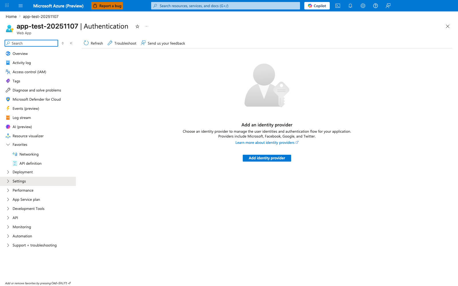 Authentication blade for the Web App with a minimal command bar offering Refresh, Troubleshoot, and Send us your feedback actions. The main content area is an empty state with a large silhouette-and-key avatar icon, a heading "Add an identity provider", a subtitle reading "Choose an identity provider to manage the user identities and authentication flow for your application. Providers include Microsoft, Facebook, Google, and Twitter.", a "Learn more about identity providers" link, and a primary blue "Add identity provider" call-to-action button. The left navigation has the Settings group highlighted.
