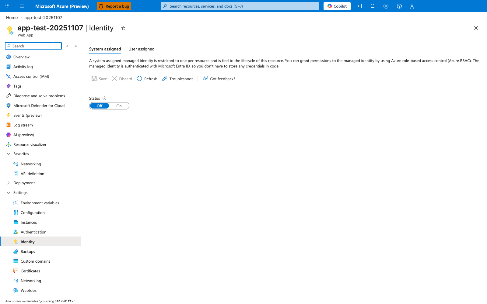 Identity blade for a Web App showing tabs "System assigned" (selected) and "User assigned". The System assigned panel displays a Status toggle currently "Off" with description "When enabled, Azure will create an identity for this resource in Microsoft Entra ID". Save and Discard buttons appear at the top; below the Status row a "Permissions" section explains role assignments for the identity, and the Object (principal) ID field is empty pending enablement. The left navigation shows Identity selected under the Settings group.