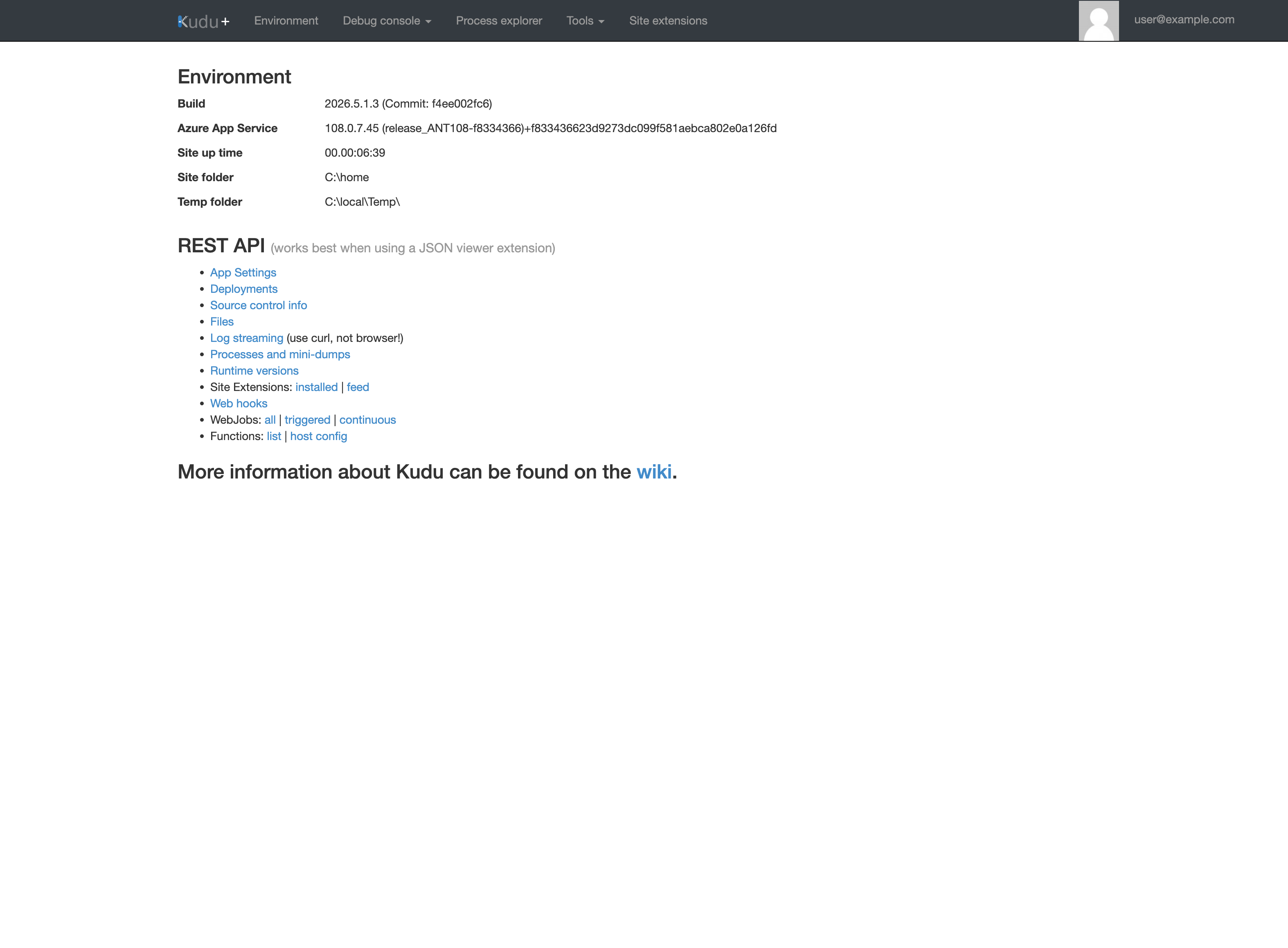 Kudu+ Environment home page. Top navigation lists Environment, Debug console (dropdown), Process explorer, Tools (dropdown), Site extensions, and a user@example.com (PII masked) account label. The Environment heading lists Build 2026.5.1.3 (Commit: f4ee002fc6), Azure App Service 108.0.7.45 (release_ANT108-f8334366)+f833436623d9273dc099f581aebca802e0a126fd, Site up time 00.00:06:39, Site folder C:\home, Temp folder C:\local\Temp. The REST API heading with caption "(works best when using a JSON viewer extension)" is followed by a list of items: App Settings, Deployments, Source control info, Files, Log streaming (use curl, not browser!), Processes and mini-dumps, Runtime versions, Site Extensions (installed | feed), Web hooks, WebJobs (all | triggered | continuous), Functions (list | host config). The footer states "More information about Kudu can be found on the wiki."
