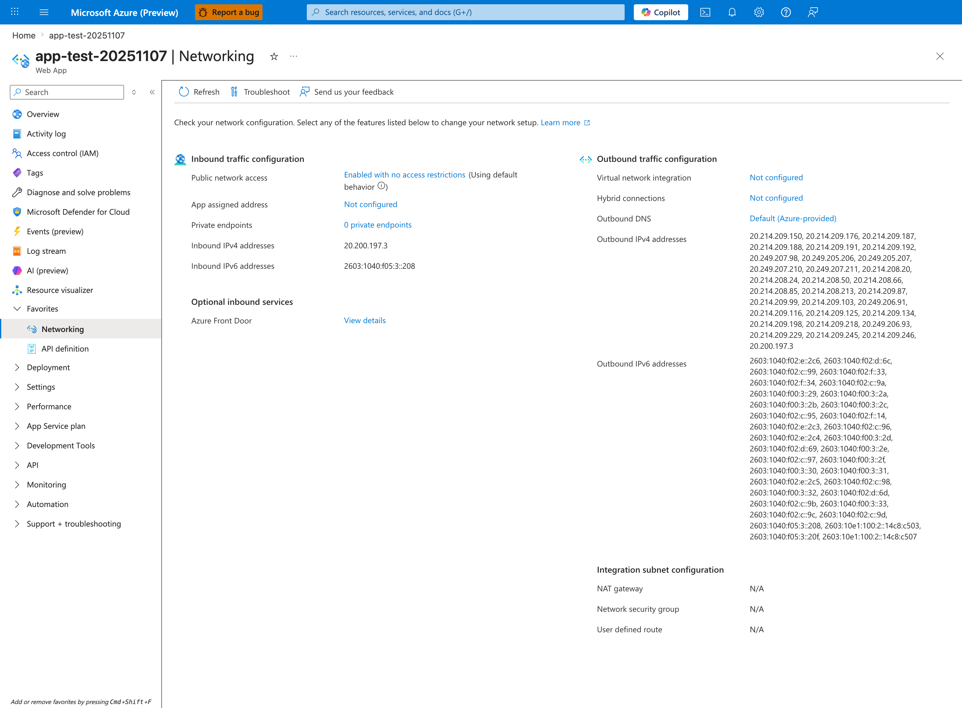 Azure portal Networking blade for app-test-20251107 (Web App) with toolbar Refresh, Troubleshoot, Send us your feedback and a "Check your network configuration..." description with a Learn more link. Two-column layout: Inbound traffic configuration shows Public network access "Enabled with no access restrictions (Using default behavior)", App assigned address "Not configured", Private endpoints "0 private endpoints", Inbound IPv4 addresses 20.200.197.3, Inbound IPv6 addresses 2603:1040:f05:3::208, plus Optional inbound services with Azure Front Door "View details". Outbound traffic configuration shows Virtual network integration "Not configured", Hybrid connections "Not configured", Outbound DNS "Default (Azure-provided)", and a long Outbound IPv4 addresses list (20.214.209.150, 20.214.209.176, 20.214.209.187, ... ~30 platform-pool addresses) plus an Outbound IPv6 addresses list. Integration subnet configuration shows NAT gateway, Network security group, and User defined route all N/A. Left nav highlights Networking (under Favorites).